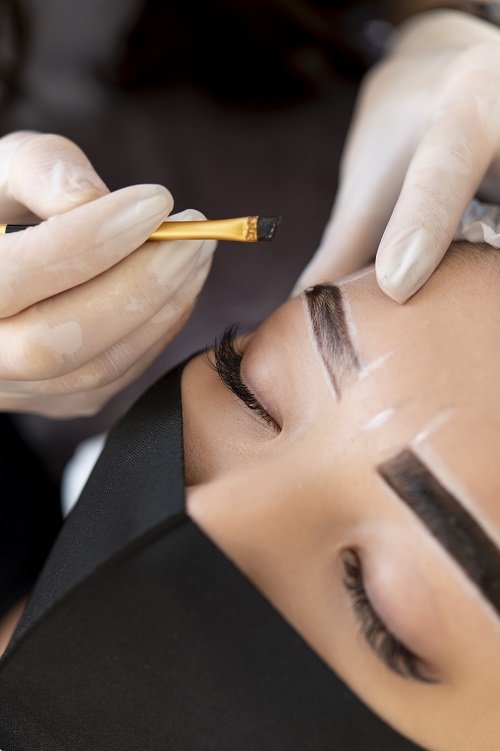 beautician-doing-microblading-treatment-client-s-eyebrows